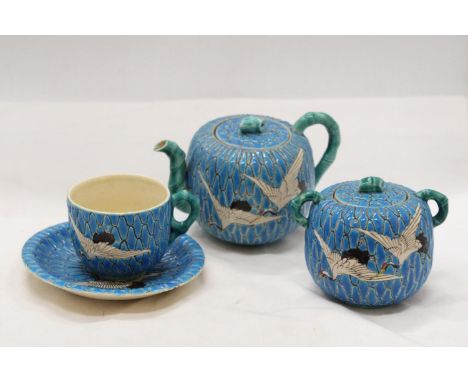 A JAPANESE SATSUMA BLUE MORRIAGE CRANE TEAPOT, LIDDED SUGAR BOWL, TEACUP AND SAUCER 