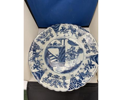 A QING DYNASTY KANGXI STYLE BLUE AND WHITE PORCELAIN SHALLOW BOWL - 44 CM DIAMETER 