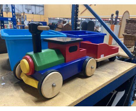 A SMALL CHILD'S WOODEN RIDE ON TRACTOR AND TRAILER 