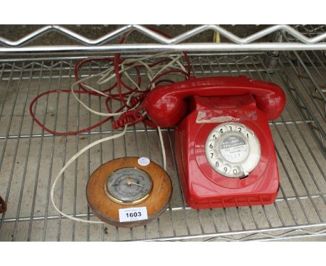 A RED RETRO ROTARY DIAL TELEPHONE AND A WOODEN CASED BAROMETER 