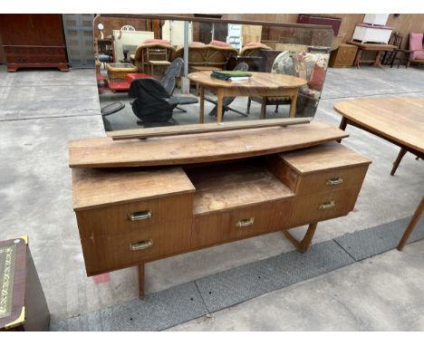 A RETRO TEAK DRESSING TABLE WITH UNFRAMED MIRROR, UPPER SURF BOARD SHELF AND FIVE DRAWERS 