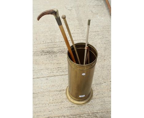 A VINTAGE BRASS STICK STAND WITH THREE VINTAGE RIDING CROPS 