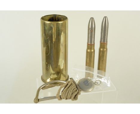 A mixed lot including two 20mm inert rounds, starter cartridge, brass case and U.S. marked compass