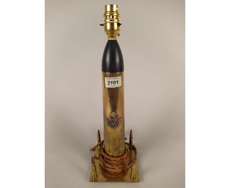 A brass shell case (inert with four rifle rounds) crafted into a table lamp with the Kings Regiment Liverpool badge