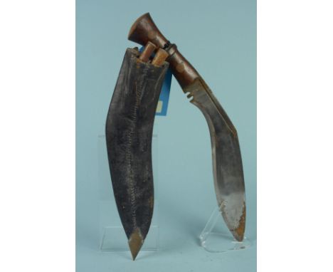 A Kukri with wooden grip and leather scabbard