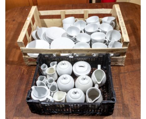 Two trays containing white cups and saucers, jugs and sugar bowls