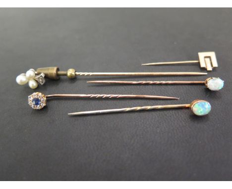 A group of five stickpins - To include opal, seed pearl and diamond, sapphire and diamond - One with 9ct gold hallmark - Two 