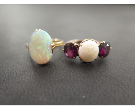 An opal single-stone ring - Tests as higher carat gold - Ring size J - Weight approx 3.5gms - Together with an opal and garne