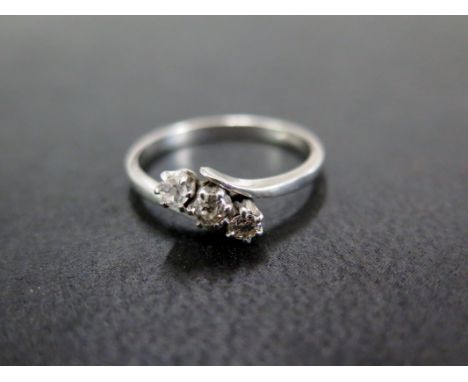 A vari-cut diamond three-stone crossover ring - Stamped plat - Ring size L - Weight approx 2.9gms
Condition Report: Good - Wi