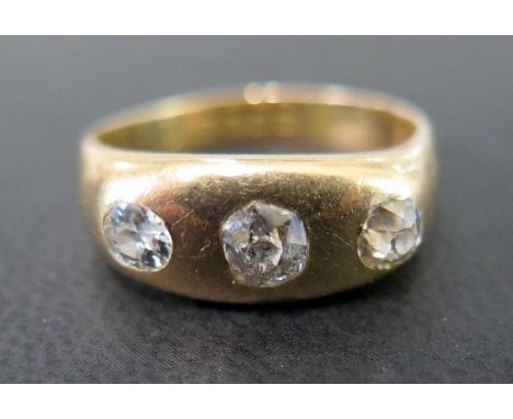 An early 20th century 18ct gold diamond three-stone ring -  - The old-cut diamonds inset to the plain band - Estimated total 