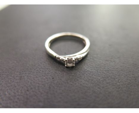 A 9ct white gold diamond ring with single brilliant cut diamond with two small diamonds to each side approx 0.2ct - ring size