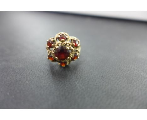 A 9ct gold garnet cluster ring - Ring size L - Weight approx 4.2gms
Condition Report: Good - With light scratches