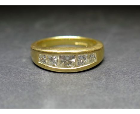 An 18ct gold diamond five-stone ring  - The graduated princess-cut diamonds within a channel setting - Estimated total diamon