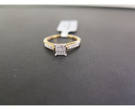 A 9ct gold diamond dress ring - The princess-cut diamond panel to the brilliant-cut diamond tapered shoulders - Estimated tot