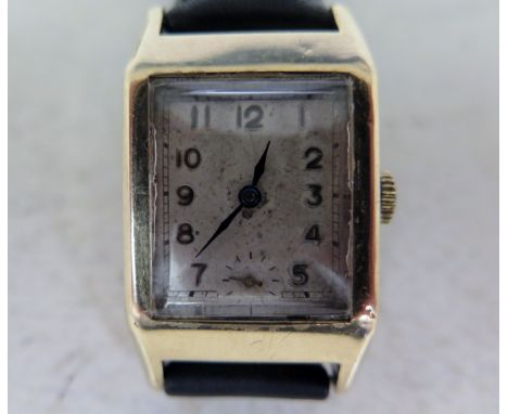 A hallmarked 9ct gold watch in rectangular Art Deco design case, Arabic numerals to dial with subsidiary second hand dial on 