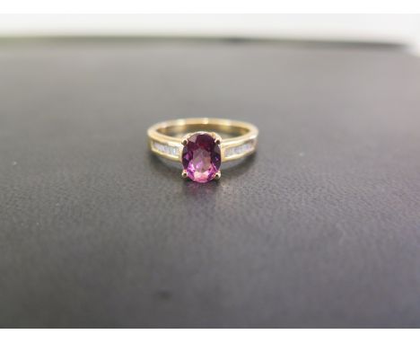 An 18ct gold tourmaline and baguette-cut diamond dress ring - Hallmarked Birmingham - Ring size N 1/2 - Weight approx 4.1gms
