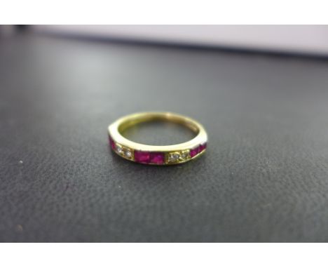 An 18ct gold ruby and diamond half-circle ring - Hallmarked London - Ring size N - Weight approx 2.3gms
Condition Report: Goo