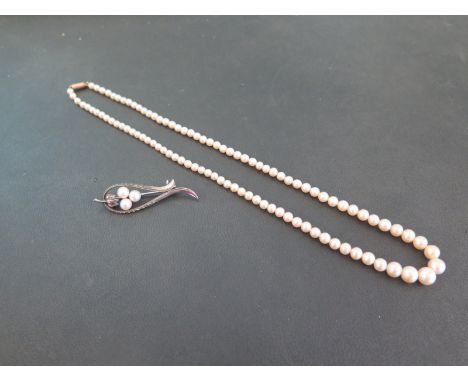 K. MIKIMOTO - a cultured pearl bar brooch - Tests as silver - Length 4.5cms - Weight approx 3.3gms - In associated case - Tog