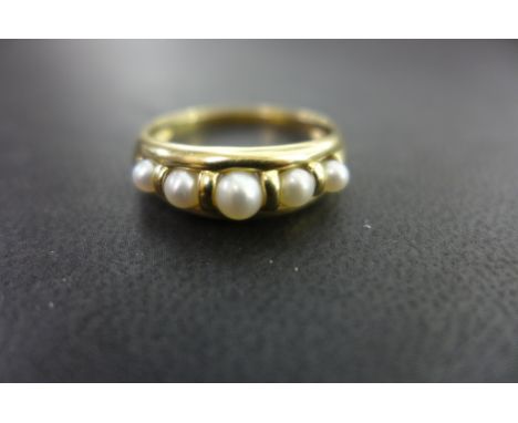 A cultured pearl dress ring - With five graduated cultured pearls - Hallmarked Sheffield - Ring size T 1/2 - Weight approx 2.