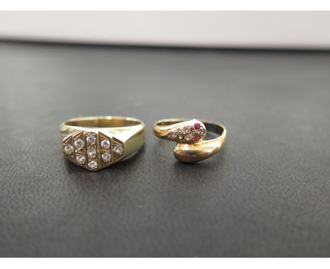 Two cubic zirconia dress rings - To include a panel ring and an ouroboros with ruby eyes - Both test as 9ct gold - Ring sizes