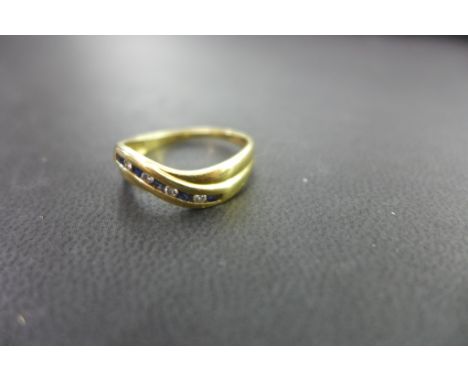 An 18ct gold sapphire and diamond crossover style band ring - Hallmarked London - Ring size Q - Weight approx 2.7gms
Conditio