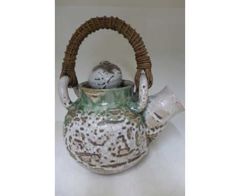 A large Oriental Artisan crackle glaze ceramic water jug with stylized decoration and wicker handle - Height 40cm - good cond