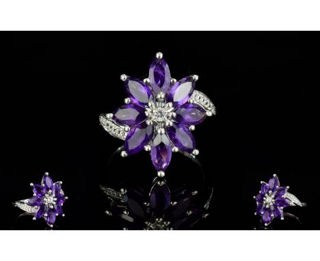 Amethyst Flower Cluster Ring, marquise cut deep purple amethysts, totalling 4cts, set in an elongated flower shape in platinu