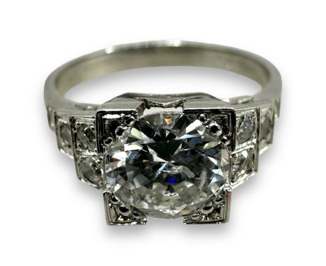 An Art Deco style diamond solitaire ring, with an estimated 1.3 carat central round brilliant cut stone. The stepped shoulder