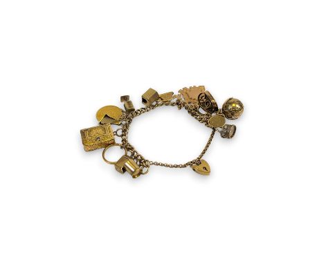 A 9ct gold charm bracelet with 15 charms to include a full sovereign, a photograph album charm, a 22ct gold band ring, a gilt