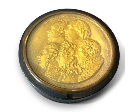 A 19th century circular tortoiseshell snuff box with gilt brass inset lid. Portraits descendants of Henry IV. Approximately 8