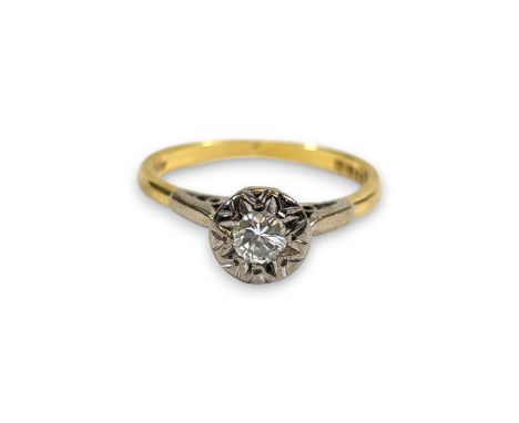 An 18ct gold illusion set diamond solitaire ring. Featuring a round brilliant cut estimated 0.20 carat. Size J 1/2. Gross wei