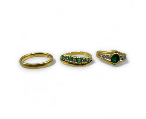Two emerald and diamond set dress rings, together with an 18ct gold band ring. Comprising a half eternity ring, with an integ