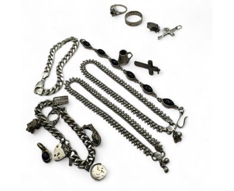 A collection of silver and white metal jewellery. Comprising a charm bracelet with five charms and a heart padlock; a hallmar