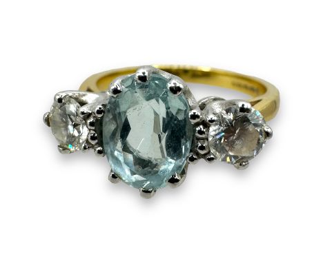 An 18ct aquamarine and diamond trilogy ring. Set with two round brilliant cut diamonds, each with an estimated carat weight o