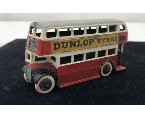 A pre-war Dinky bus wih staircase and 'Dunlop tyres' in red