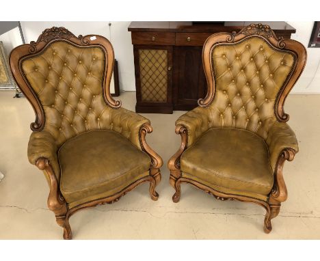A pair of Victorian-style leather button-back chairs