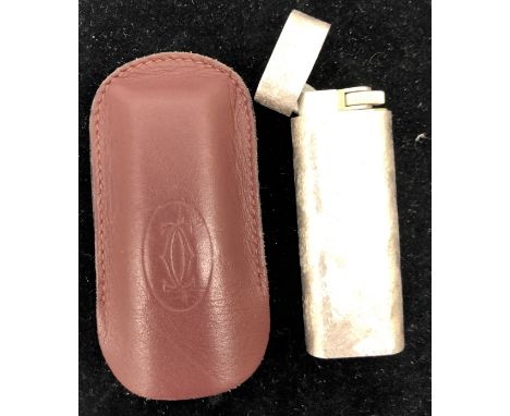 A silver-plated Cartier lighter