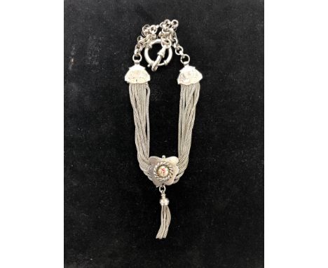 A white metal Albert chain with multi-strand enamelled button