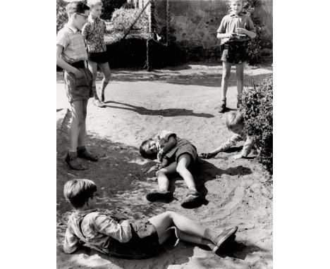 McBride, Will -- Boys playing in the sand. 1950s. Vintage ferrotyped gelatin silver print on Agfa-Brovira paper. 30 x 24 cm. 