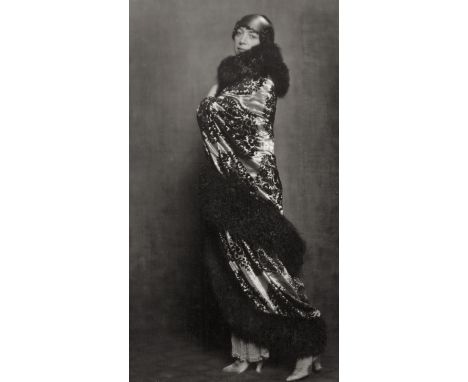 Madame D'Ora -- Madame Domergue, wife of the painter Gabriel Domergue, in a cloak designed by her husband. Circa 1920. Vintag