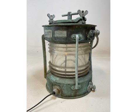 A vintage ship's anchor light with clear glass cylindrical lens and verdigris finish to the body, height 36cm.