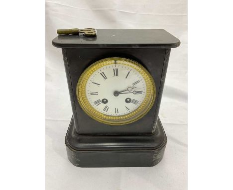 A late 19th century French black slate mantel clock with Roman numerals to the white enamel dial, and a small group of musica