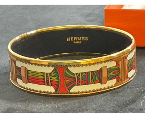 HERMES; an enamel decorated bangle in original box, internal diameter 62mm, width of bangle 17mm.