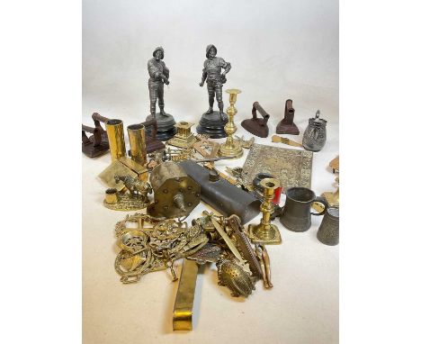 A group of metalware including a brass spit, various half ornaments, candlestick, etc.