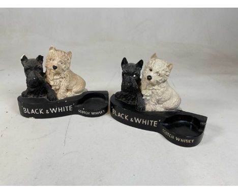A painted plaster advertising Black &amp; White Scotch Whisky bottle holder, width 31cm, and a near identical example in plas