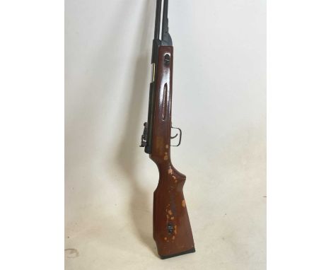A vintage air rifle with painted stock.