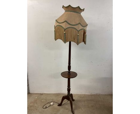 A mahogany standard lamp with central dished shelf platform, and two curtain poles (3) 