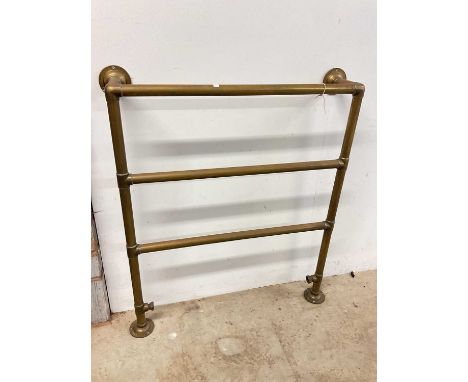 A vintage brass heated towel rail, width 80cm.