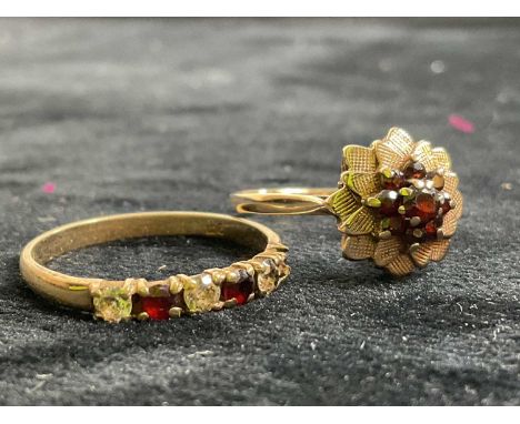 A 9ct yellow gold garnet set flower head ring, size R, and a further 9ct yellow gold dress ring, size S 1/2, combined 4.4g (2