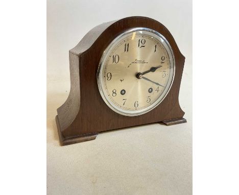 A 1940s oak mantel clock with Arabic numerals to the silvered dial, inscribed 'J.Purser Ltd Portsmouth &amp; Southampton', so